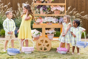 Kids with Easter baskets near stand