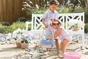 little boy and a little girl gathering easter eggs in the garden