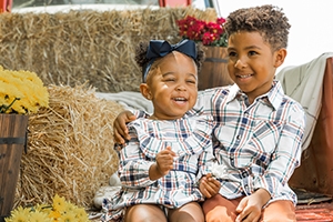 little boy and little girl in plaid outfits