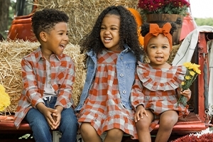 three kids in plaid outfits
