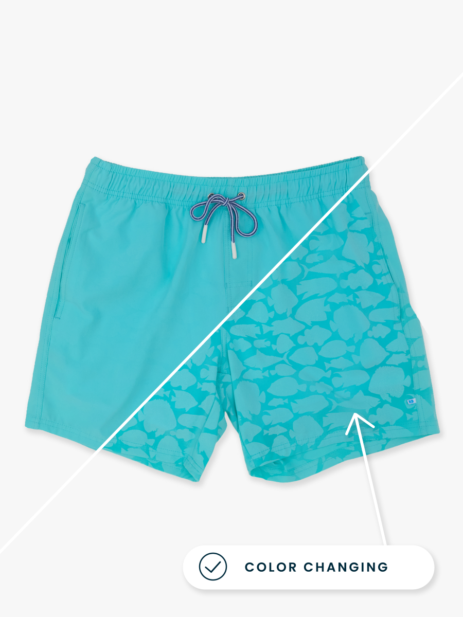 Line drawing of Bright Aqua Fish Squad Color Changing Men's Performance Hybrid Swim Trunks. A dotted circle indicates the approximate location for personalization.