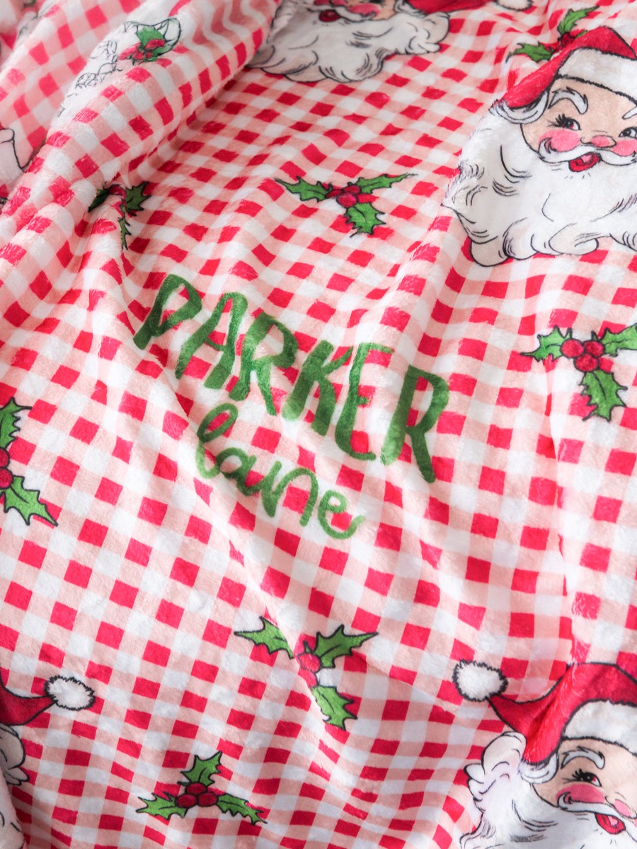 Line drawing of Printed Personalized Plush Minky Blanket-Red Dear Santa. A dotted circle indicates the approximate location for personalization.