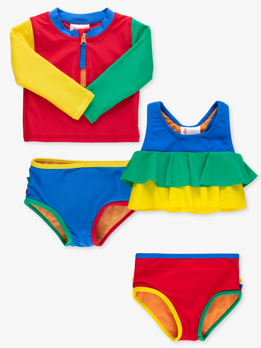 Line drawing of Primary Color Block LS Zipper RG 2P + Flounce 2P. A dotted circle indicates the approximate location for personalization.