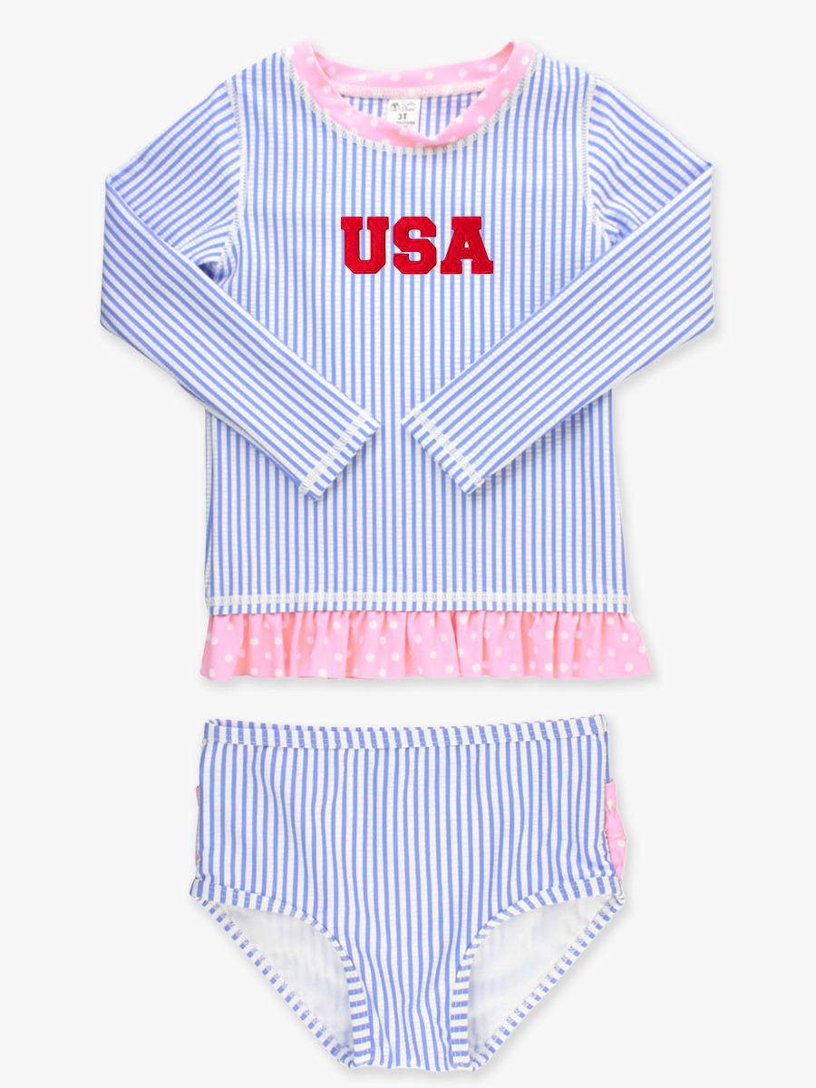 Line drawing of Red USA Embroidered Periwinkle Blue Seersucker Long Sleeve Rash Guard 2-Piece Swimsuit, with Signature Rear Ruffles. A dotted circle indicates the approximate location for personalization.