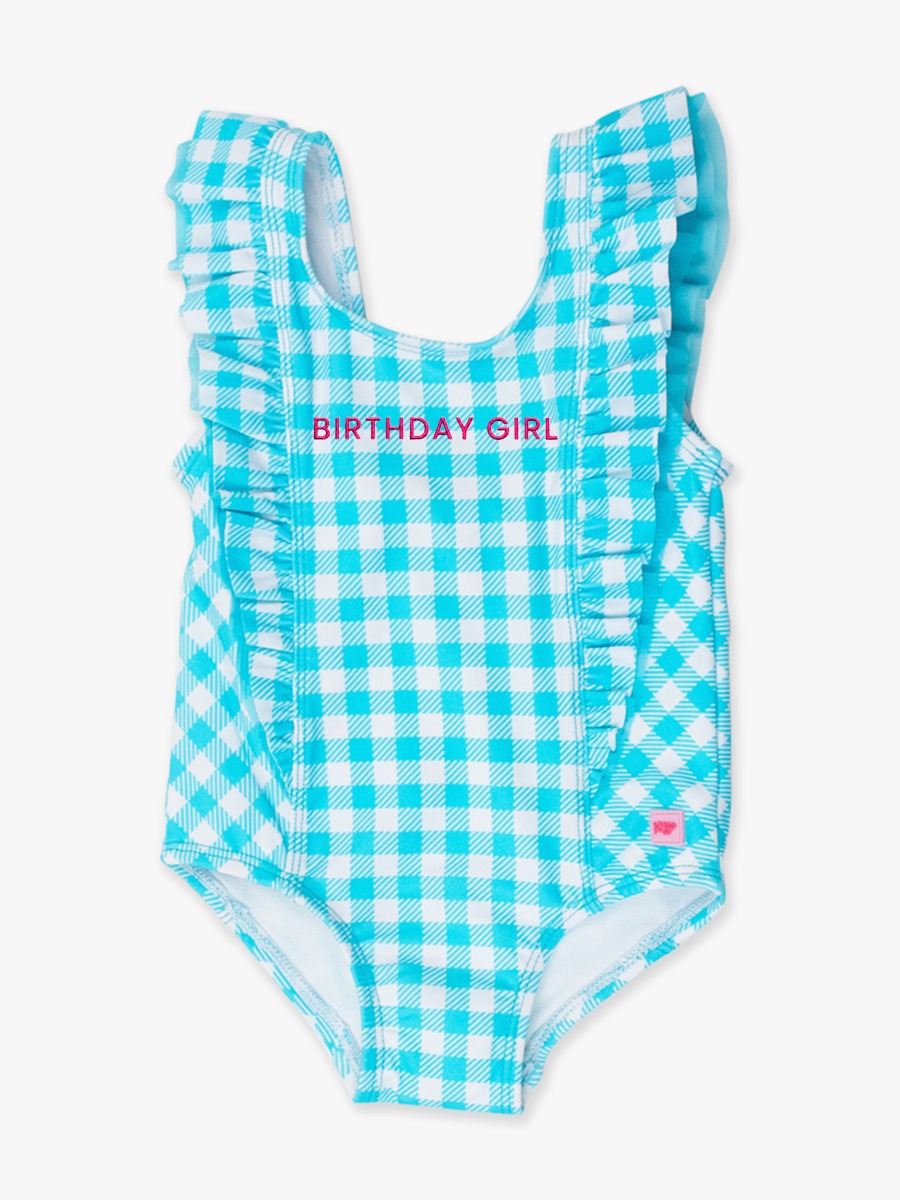Line drawing of Neon Magenta BIRTHDAY GIRL Embroidered Bright Aqua Gingham Waterfall One Piece Swimsuit. A dotted circle indicates the approximate location for personalization.