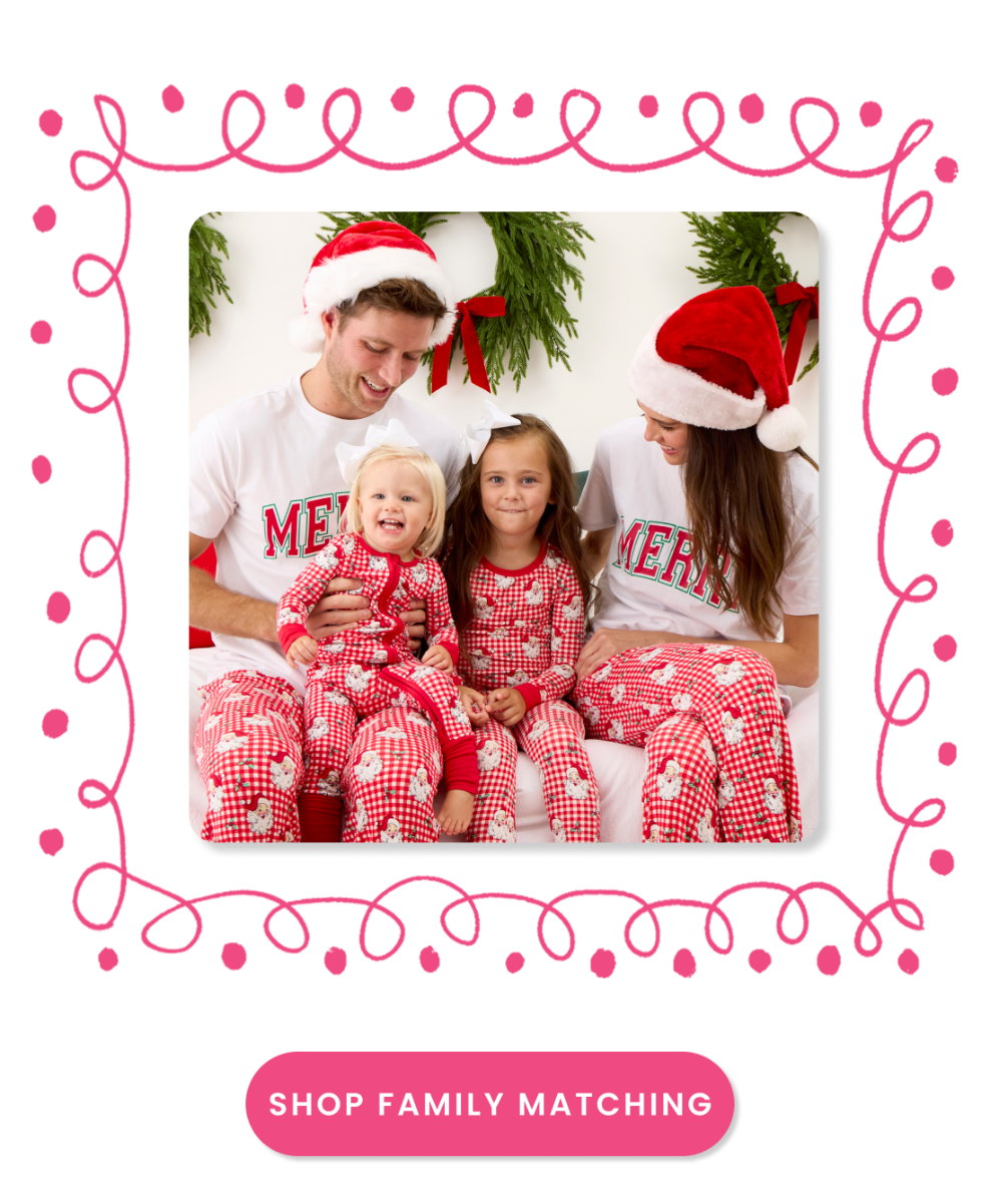 "Banner showing matching red Santa-print family pajamas with holiday wreath decorations. Includes a pink &lsquo;Shop Family Matching&rsquo; button."