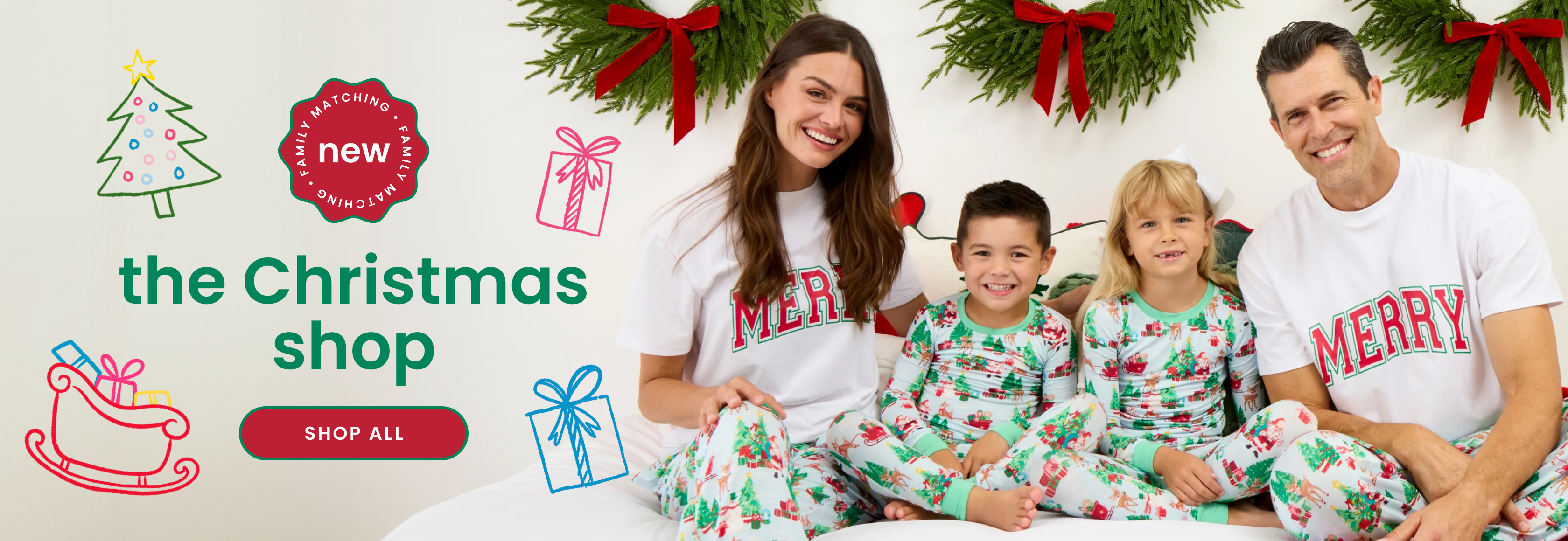 "Holiday banner reading ‘The Christmas Shop’ with a family matching badge and ‘Shop All’ button. Features coordinating Christmas pajamas with Santa, tree, gift, and reindeer prints."