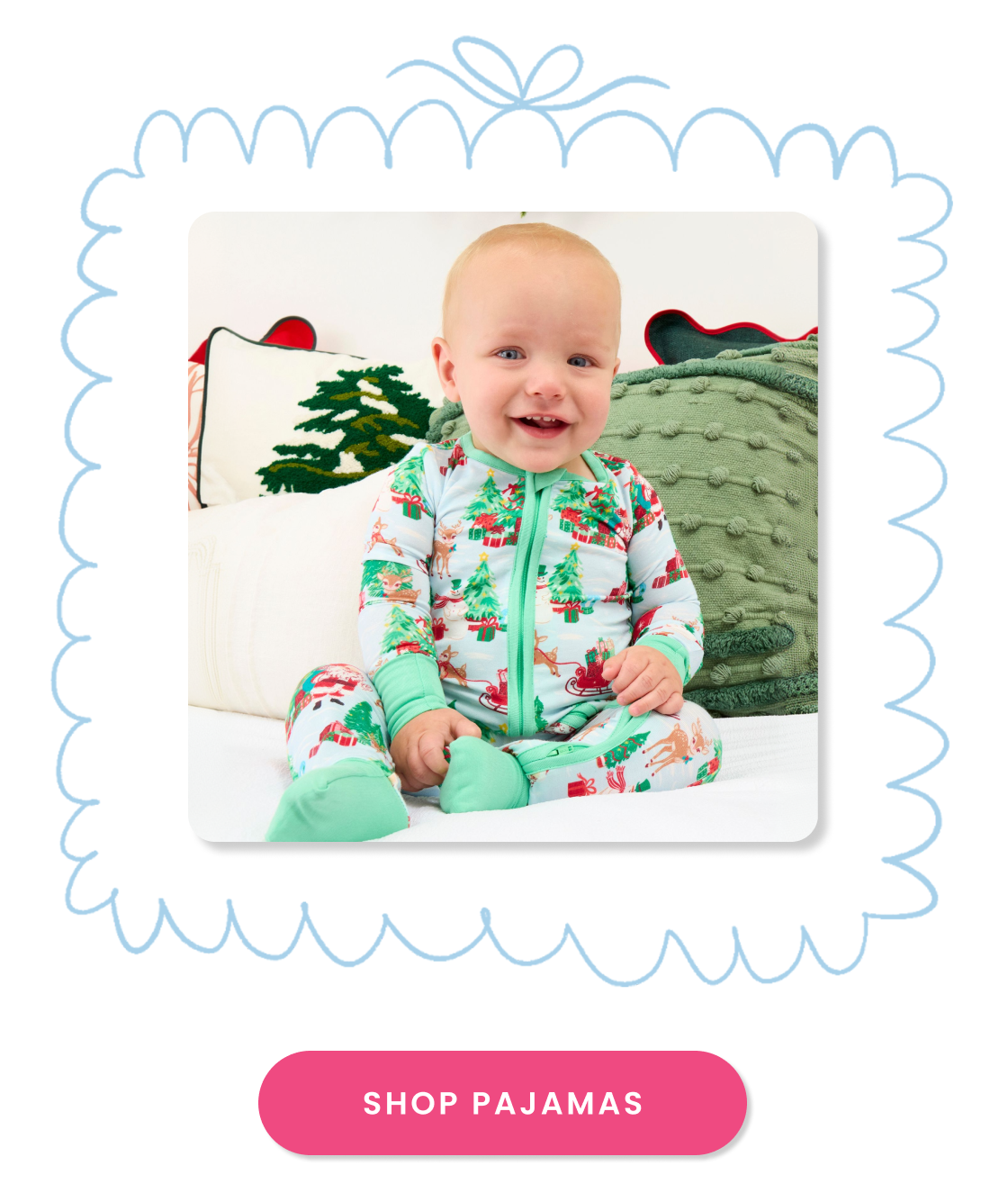 "Holiday pajama shop tile featuring a zip-front sleeper with Christmas tree, reindeer, sleigh, and gift prints. Includes a pink ‘Shop Pajamas’ button."