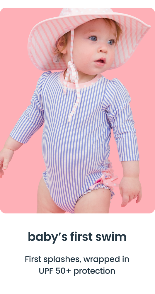 "Baby wearing a blue and white striped long‑sleeve swimsuit with a pink sun hat on a pink background. Text reads &lsquo;baby&rsquo;s first swim&rsquo; and &lsquo;First splashes, wrapped in UPF 50+ protection.&rsquo;"