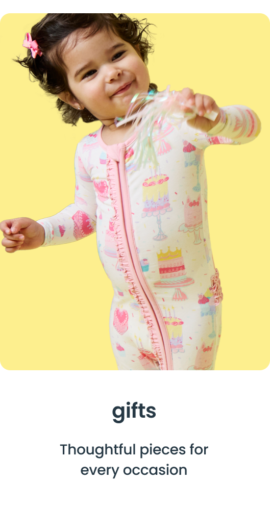 "Toddler wearing a zip‑front one‑piece with cake and sprinkle prints, holding a ribbon wand on a yellow background. Text reads &lsquo;gifts&rsquo; and &lsquo;Thoughtful pieces for every occasion.&rsquo;"