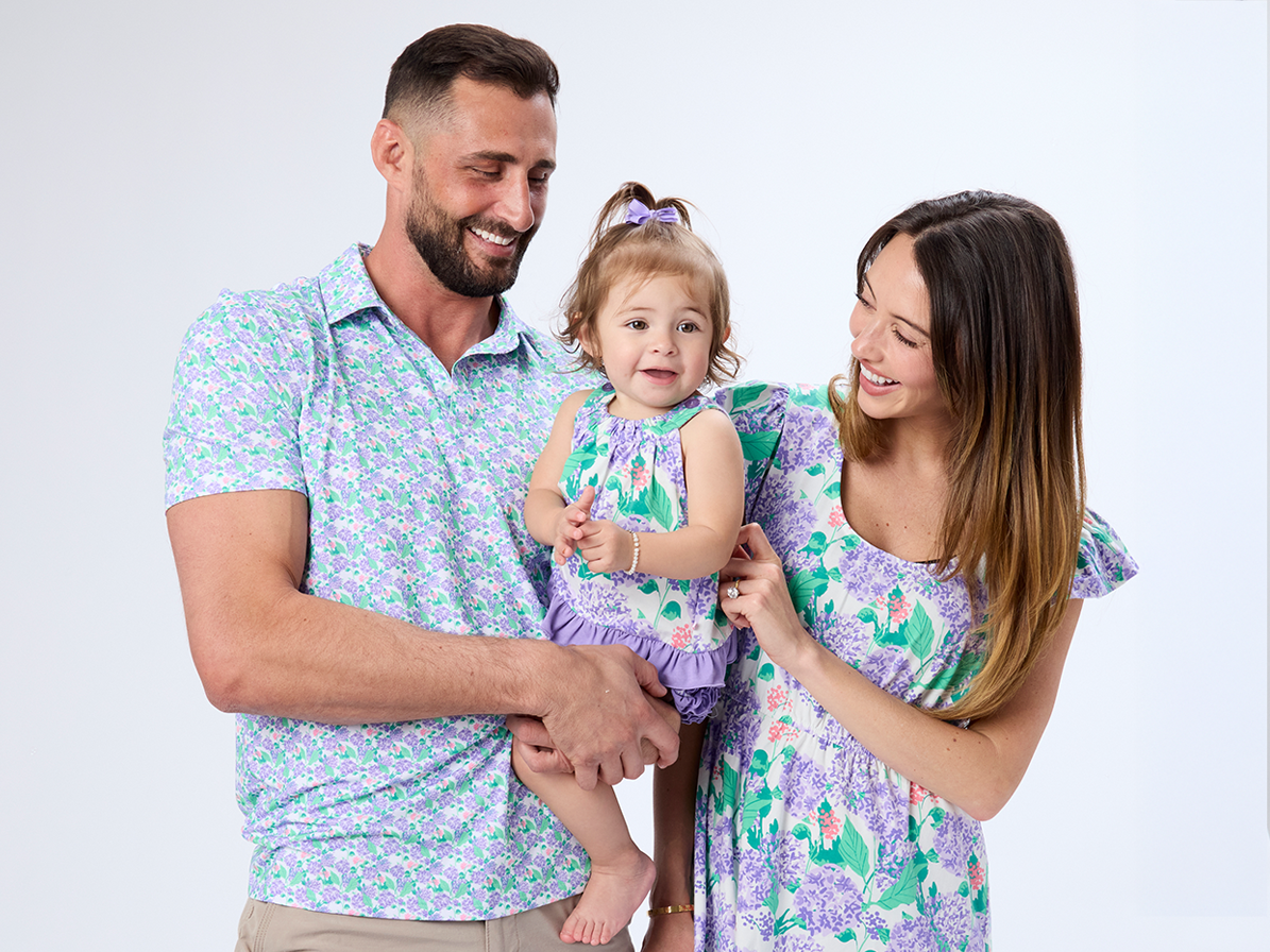 3 little kids in matching shamrock apparel against a pink background with shamrock cut outs beheind them.  Image links to the St Patricks collection.