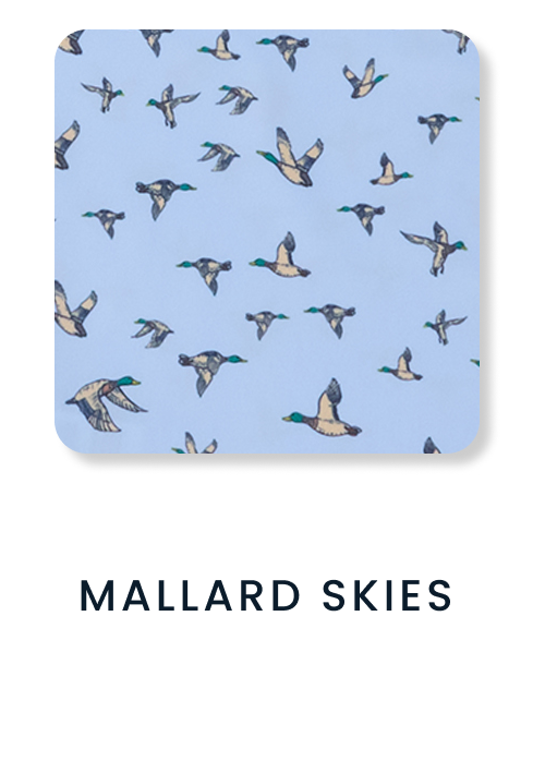 Shop By Print tile featuring a light blue pattern with flying mallard ducks. Text reads ‘Mallard Skies.