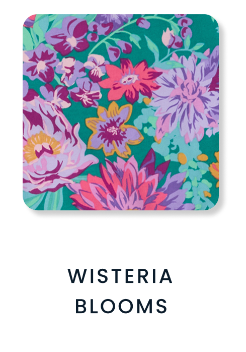 Shop By Print tile featuring a vibrant floral pattern with pink, purple, yellow, and teal flowers. Text reads ‘Wisteria Blooms.