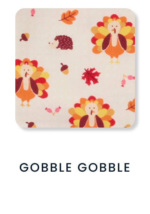 Shop By Print tile featuring a pink Halloween pattern with jack‑o’‑lantern candy buckets, candy, and candy corn. Text reads ‘Pumpkin Boo Crew.