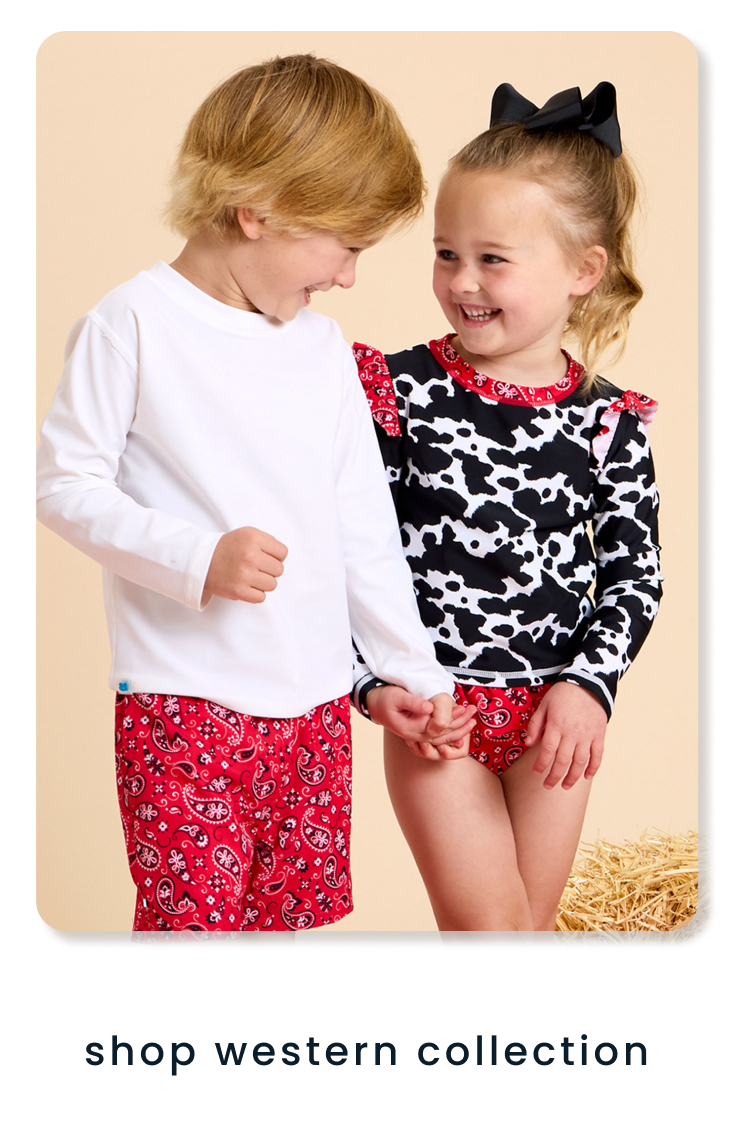 "Two children wearing western‑inspired outfits, including cow‑print and red bandana styles, standing near hay. Text below reads ‘shop western collection.’"