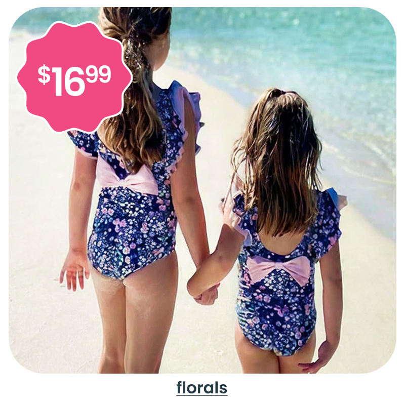 "Beach image showing two children walking along the shoreline in navy floral swimsuits with bow details. A pink badge reads &lsquo;$16.99.&rsquo; Text below reads &lsquo;florals.&rsquo;"