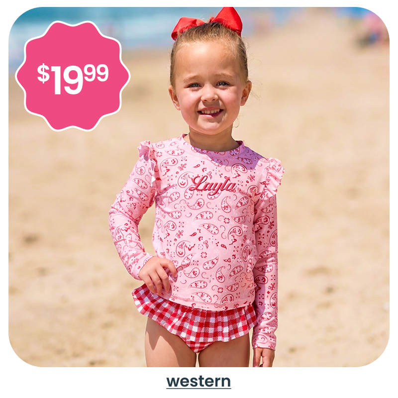 "Beach image showing a child in a pink western‑print rash guard and red gingham swim bottoms. A pink badge reads &lsquo;$19.99.&rsquo; Text below reads &lsquo;western.&rsquo;"